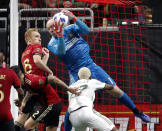 Atlanta United goalkeeper Brad Guzan (1) makes a save in front of Portland Timbers forward Dairon Asprilla (27) during the second half of the MLS Cup championship soccer game, Saturday, Dec. 8, 2018, in Atlanta. Atlanta won 2-0. (AP Photo/John Bazemore)