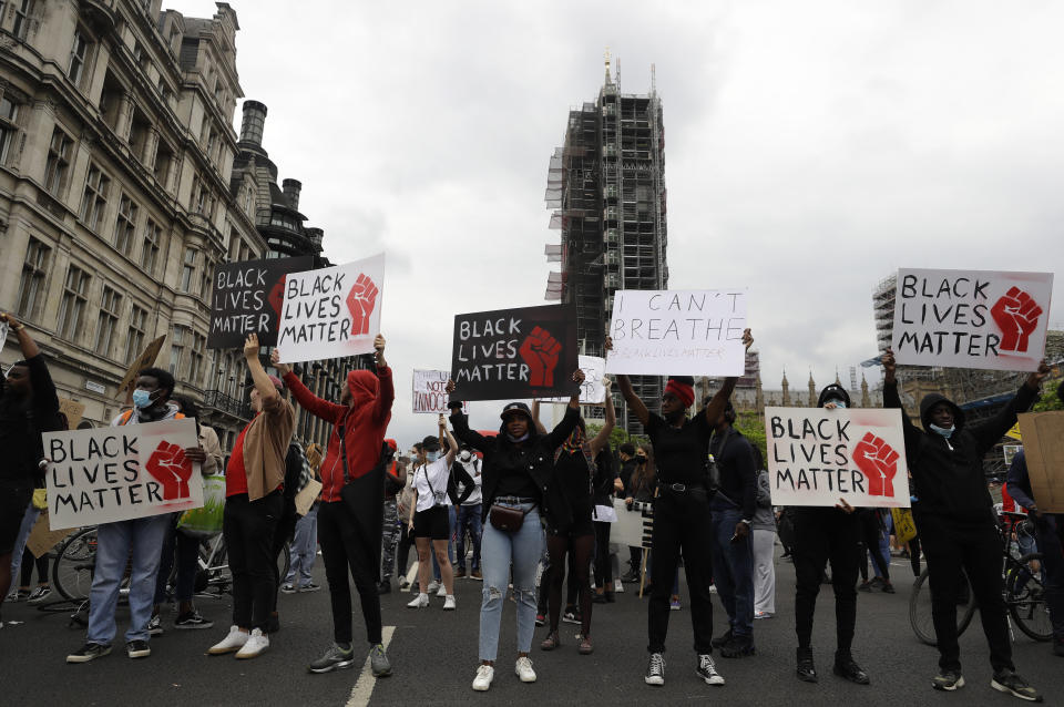 Protesters stand in the road during a demonstration in Parliament Square in London on Wednesday, June 3, 2020, over the death of George Floyd, a black man who died after being restrained by Minneapolis police officers on May 25. Protests have taken place across America and internationally, after a white Minneapolis police officer pressed his knee against Floyd's neck while the handcuffed black man called out that he couldn't breathe. The officer, Derek Chauvin, has been fired and charged with murder. (AP Photo/Kirsty Wigglesworth)