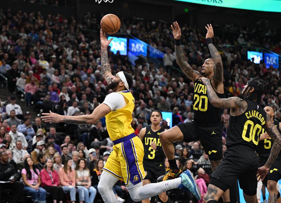 Los Angeles Lakers forward Anthony Davis (3) Throughs up a prayer as Utah Jazz forward <a class="link " href="https://sports.yahoo.com/nba/players/5832/" data-i13n="sec:content-canvas;subsec:anchor_text;elm:context_link" data-ylk="slk:John Collins;sec:content-canvas;subsec:anchor_text;elm:context_link;itc:0">John Collins</a> (20) defends him at the hoop as the Utah Jazz and the Los Angeles Lakers play at the Delta Center in Salt Lake City on 2/14/24. LA won 138-122. | Scott G Winterton, Deseret News