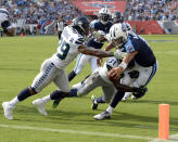 <p>Tennessee Titans quarterback Marcus Mariota (8) reaches for the goal line as he is hit by Seattle Seahawks defenders Earl Thomas (29) and Kam Chancellor (31) in the first half of an NFL football game Sunday, Sept. 24, 2017, in Nashville, Tenn. The play was called back because of a penalty. (AP Photo/Mark Zaleski) </p>