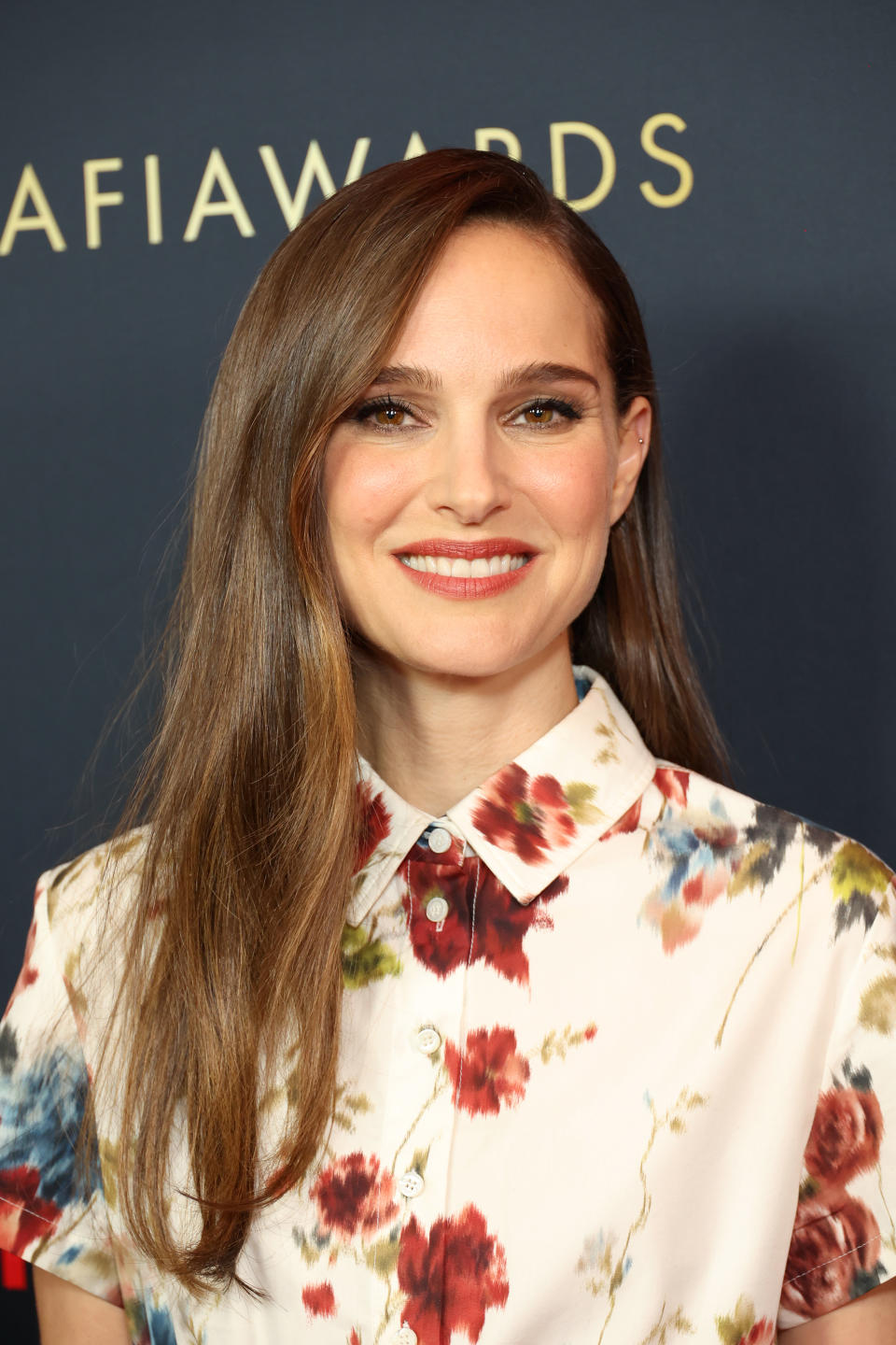 closeup of natalie smilng in a floral blouse