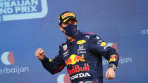 Red Bull driver Sergio Perez of Mexico celebrates on the podium after winning the Formula One Grand Prix at the Baku Formula One city circuit in Baku, Azerbaijan, Sunday, June 6, 2021. (Maxim Shemetov, Pool via AP)