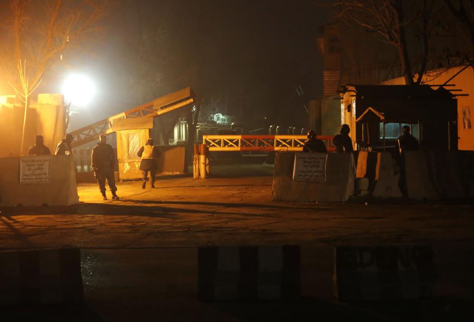 Afghan security personnel keep watch at the gate near the site of an explosion at Camp Eggers in Kabul