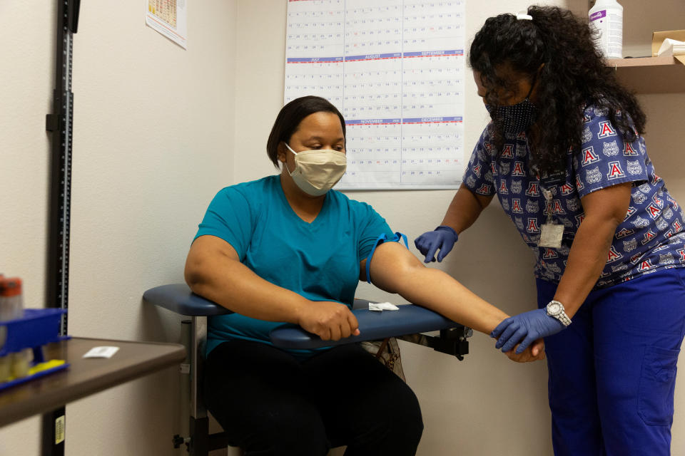 Tokemia Rios, an employee of El Rio Health Clinic, has her arm swabbed before her blood is drawn for an antibody test for the coronavirus disease (COVID-19) at the University of Arizona in Tucson, Arizona, U.S., July 10, 2020. REUTERS/Cheney Orr