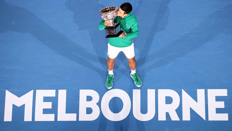 2020 Australian Open champion Novak Djokovic poses with the trophy at Melbourne Park.