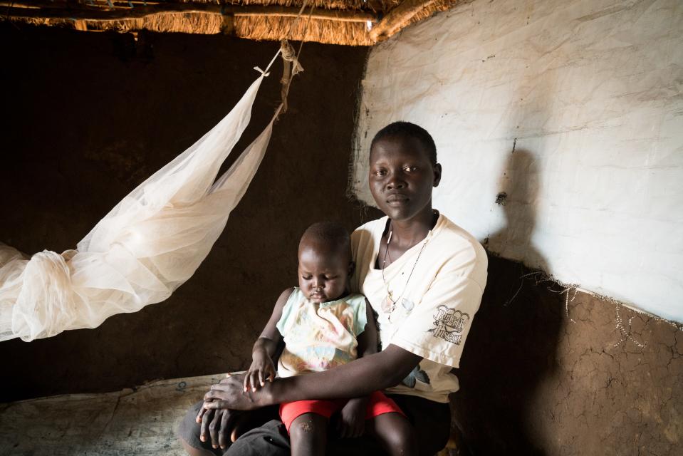 Helen Keji, 19, with her son Nicholas, 2, in their home in the Bidi Bidi settlement, June 26, 2019