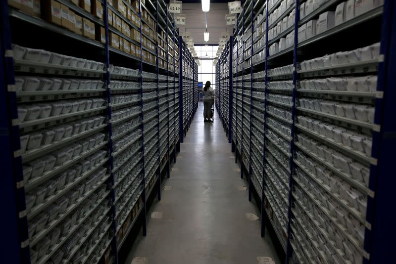 An employee works in the warehouse at the Krys optical group factory in Bazainville