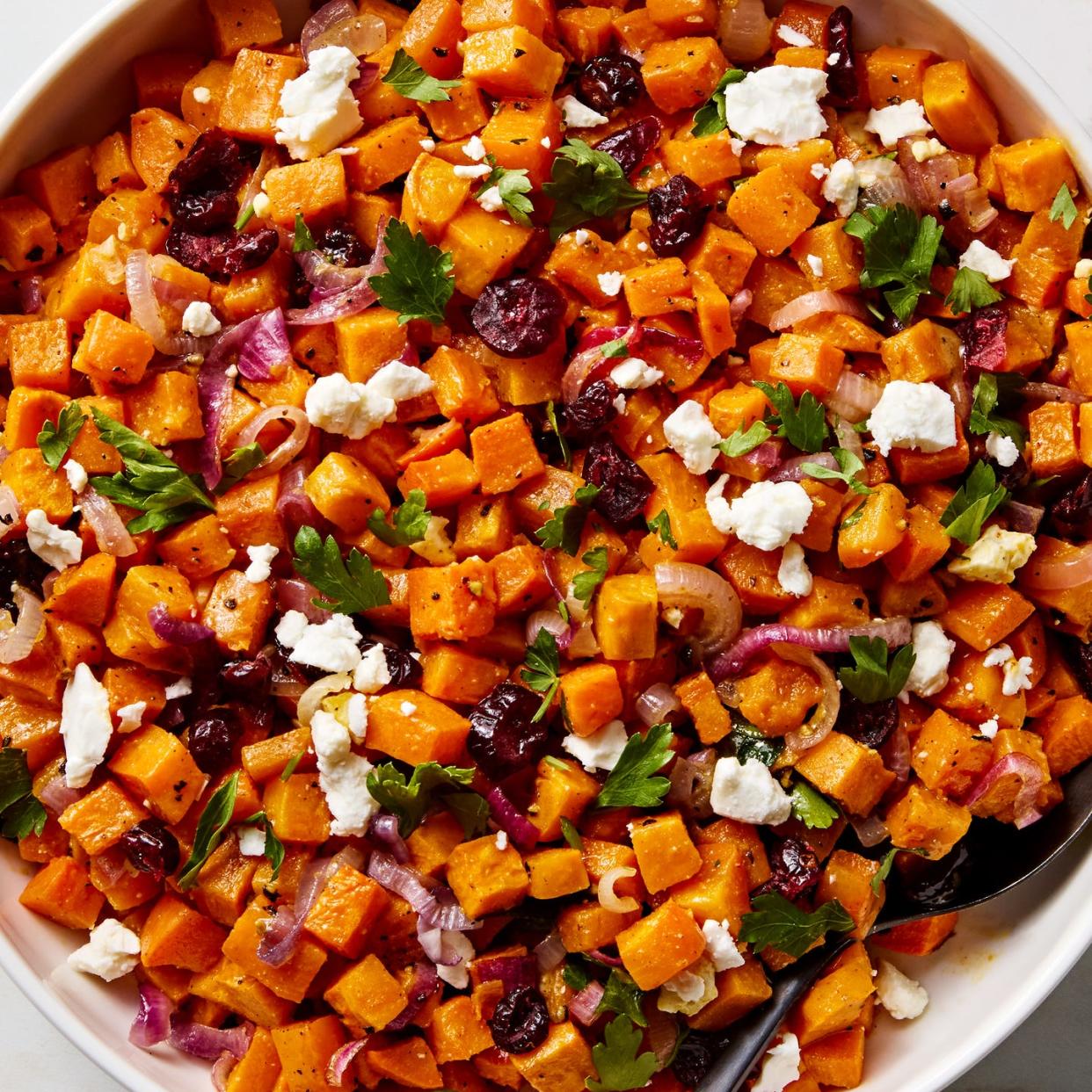 cubes of sweet potato with crumbled feta, red onion, dried cranberries, and parsley