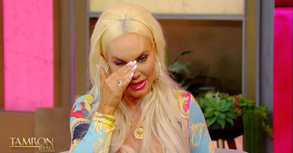 Coco Austin wipes tears from her eyes during an interview with E! News. 