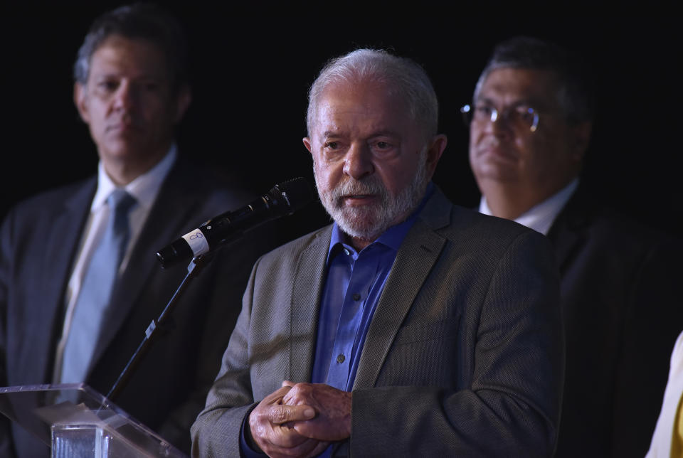 Brazilian President-elect Luiz Inacio Lula da Silva, center, announces his choices for some ministers during a press conference at his transition team's headquarters in Brasilia, Brazil, Friday, Dec. 9 2022. Lula da Silva revealed on Friday some of the faces that will compose his future administration, starting Jan. 1, including his much-awaited pick for Finance Minister: former Sao Paulo mayor Fernando Haddad. (AP Photo/Ton Molina)