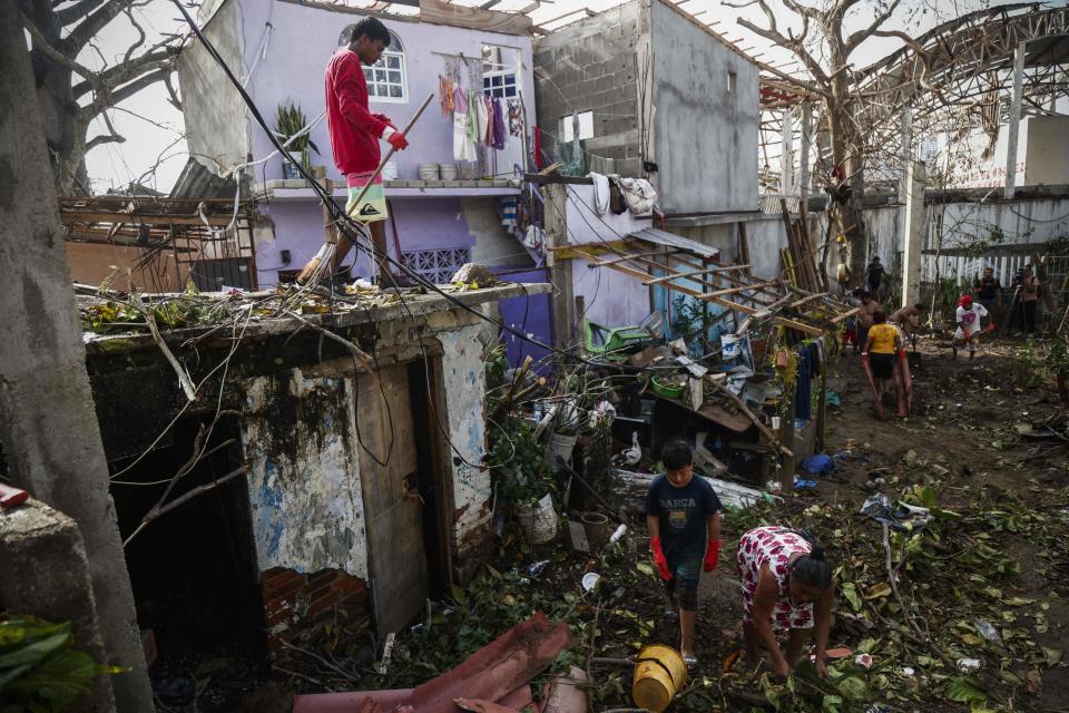 People remove debris left by the passage of Hurricane Otis in Puerto Marques, Guerrero State, Mexico, on Oct. 28, 2023.  / Credit: RODRIGO OROPEZA/AFP via Getty Images