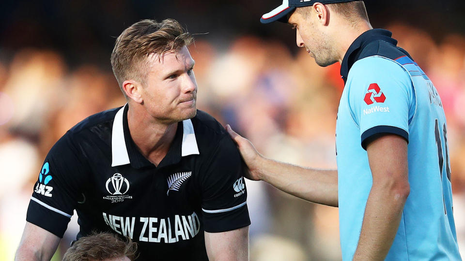 Chris Woakes consoles Jimmy Neesham after the heartbreaking super over saw England crowned champs. (Photo by Michael Steele/Getty Images)