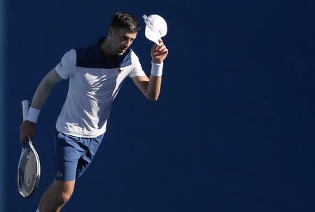 Tennis - Australian Open - Margaret Court Arena, Melbourne, Australia, January 16, 2018. Novak Djokovic of Serbia reacts during his match against Donald Young of the U.S. REUTERS/Issei Kato