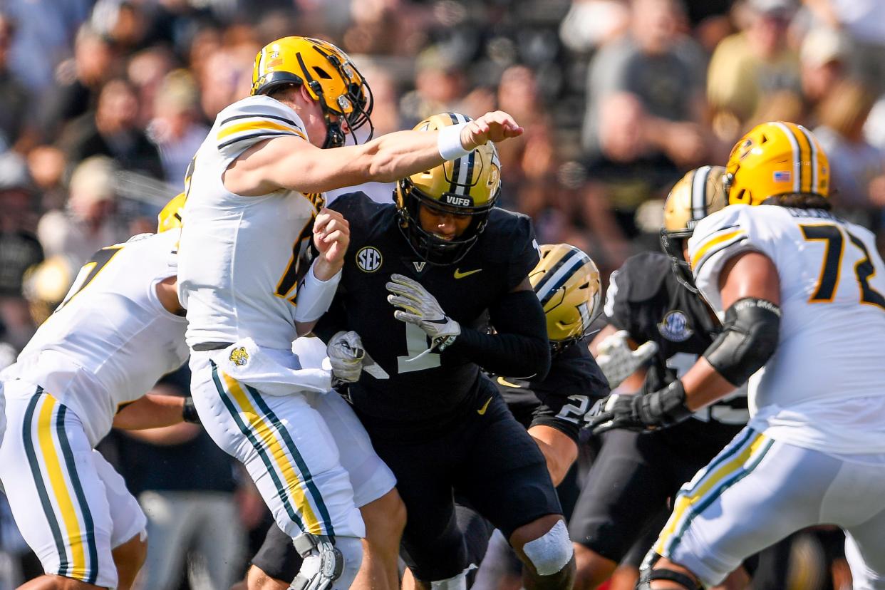 Sep 30, 2023; Nashville, Tennessee, USA; Vanderbilt Commodores linebacker CJ Taylor (1) hits Missouri Tigers quarterback Brady Cook (12) just after he release the ball during the first half at FirstBank Stadium. Mandatory Credit: Steve Roberts-USA TODAY Sports