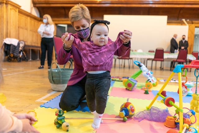 Meeting nine-month-old Amelia Mackinnon and other families during a visit at Govan Help in Glasgow in 2022 (