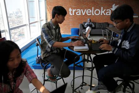 Employees of Traveloka are seen working at the company's headquarters in Jakarta, Indonesia, August 2, 2017. REUTERS/Beawiharta