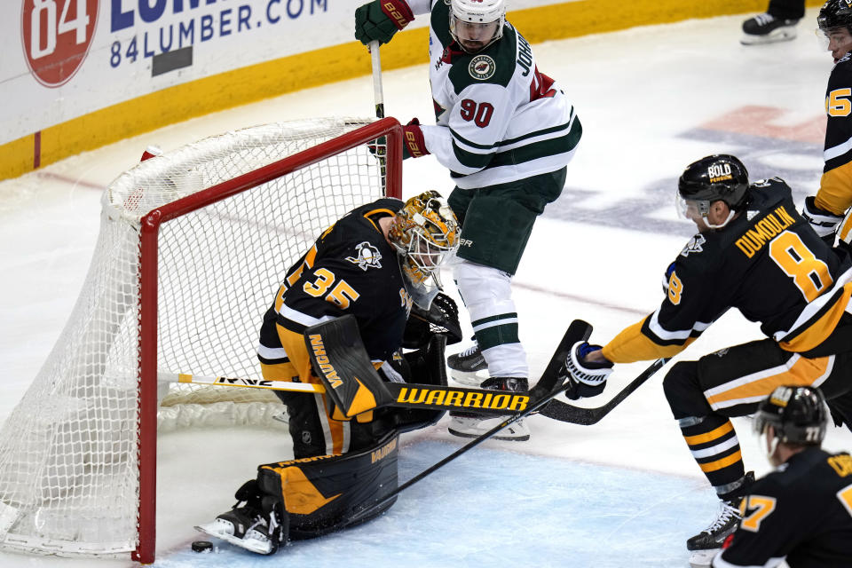 A shot by Minnesota Wild's Marcus Johansson (90) bounces in and out of the net behind Pittsburgh Penguins goaltender Tristan Jarry (35), for a goal during the third period of an NHL hockey game in Pittsburgh, Thursday, April 6, 2023. (AP Photo/Gene J. Puskar)
