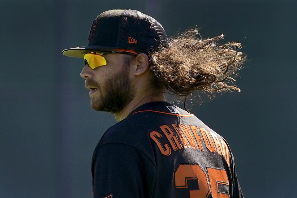 San Francisco Giants' Brandon Crawford takes the field during spring training baseball workouts, Tuesday, March 15, 2022, in Scottsdale, Ariz. (AP Photo/Matt York)