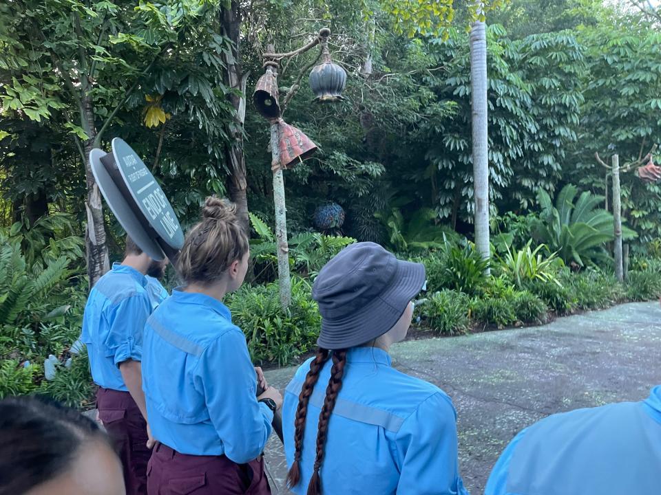 disney world cast members walking guests in for rope drop at animal kingdom