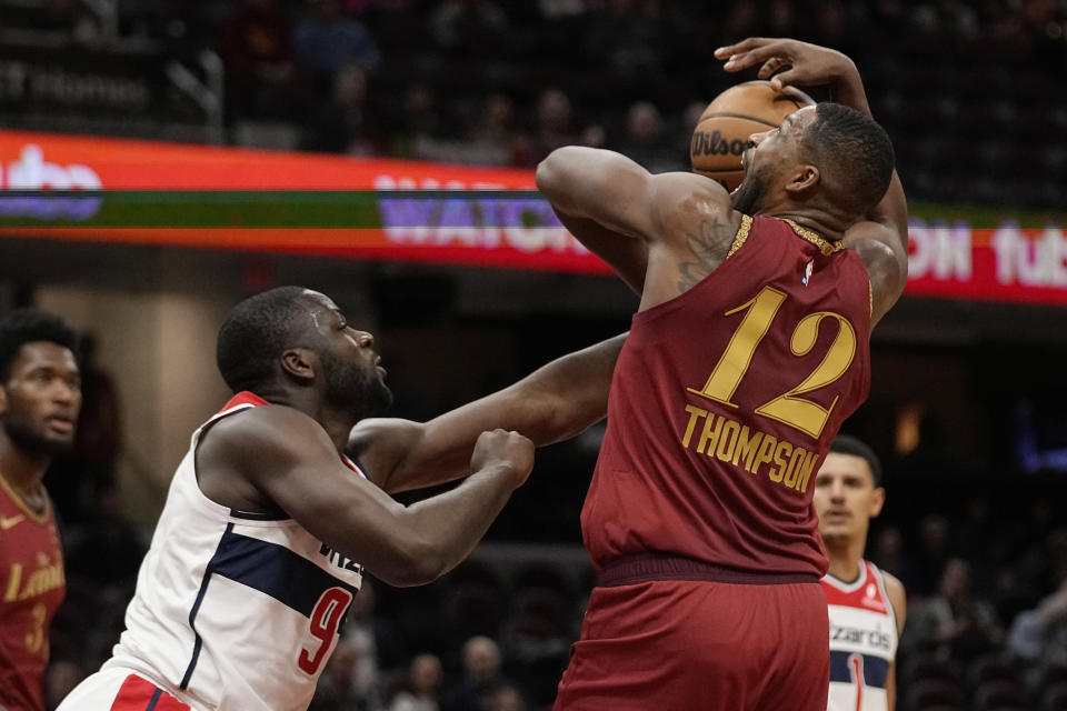 Washington Wizards forward Eugene Omoruyi, left, fouls Cleveland Cavaliers center Tristan Thompson (12) in the second half of an NBA basketball game Wednesday, Jan. 3, 2024 in Cleveland. (AP Photo/Sue Ogrocki)