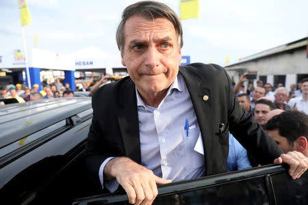 FILE PHOTO: Presidential candidate Jair Bolsonaro leaves an agribusiness fair in Esteio, Rio Grande do Sul state, Brazil August 29, 2018. REUTERS/Diego Vara/File photo