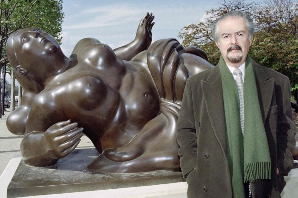 Colombian sculptor Fernando Botero poses in front of one of his works on the Champs Elysees avenue in Paris on Oct. 16, 1992.