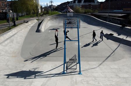 People play basketball at Superkilen park in Copenhagen, Denmark April 22, 2016. Picture taken April 22, 2016. Aga Khan Award for Architecture/Handout via REUTERS