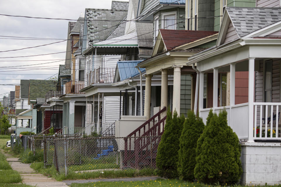 Houses along Riley Street near Tops Friendly Market are seen on Tuesday, May 17, 2022, in Buffalo, N.Y. As the only supermarket for miles, residents say Tops Friendly Market was a sort of community hub where they chatted with neighbors and caught up on each other’s lives. (AP Photo/Joshua Bessex)