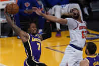 Los Angeles Lakers guard Ben McLemore (7) catches a rebound against New York Knicks center Taj Gibson (67) during the second quarter of a basketball game Tuesday, May 11, 2021, in Los Angeles. (AP Photo/Ashley Landis)