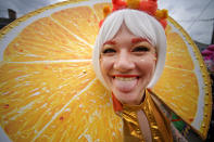 Reveler Anna Comarovschi is dressed as an orange slide as she marches in the St. Anne parade through the Marigny on Mardi Gras Day in New Orleans, Tuesday, Feb. 25, 2020. (Max Becherer/The Advocate via AP)