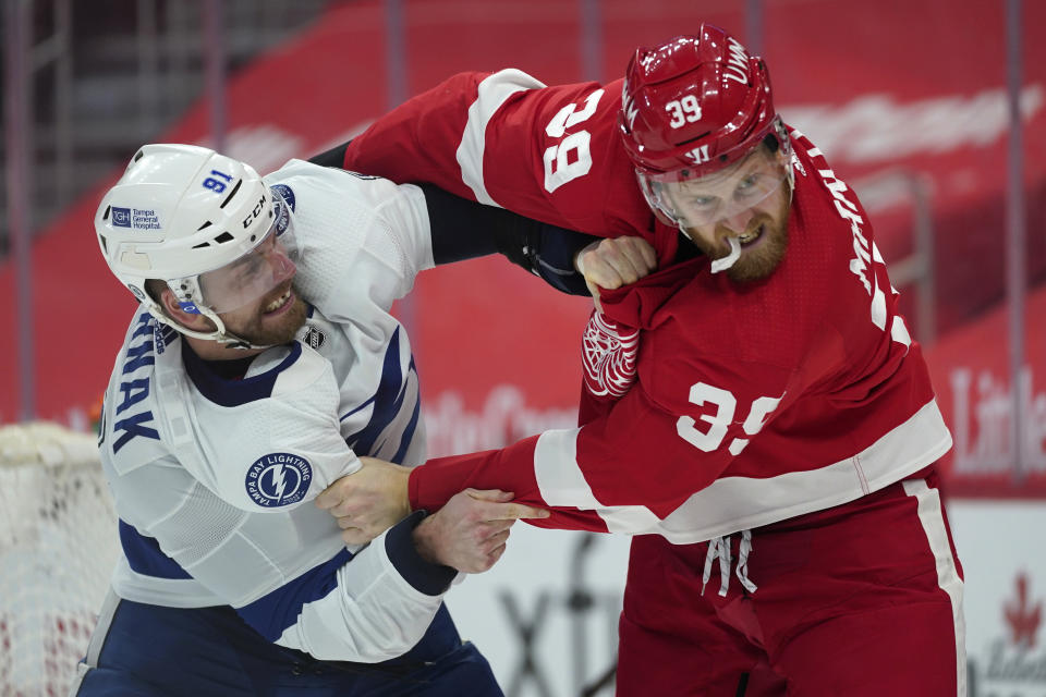 Tampa Bay Lightning defenseman Erik Cernak (81) and Detroit Red Wings right wing Anthony Mantha (39) fight in the second period of an NHL hockey game Tuesday, March 9, 2021, in Detroit. (AP Photo/Paul Sancya)