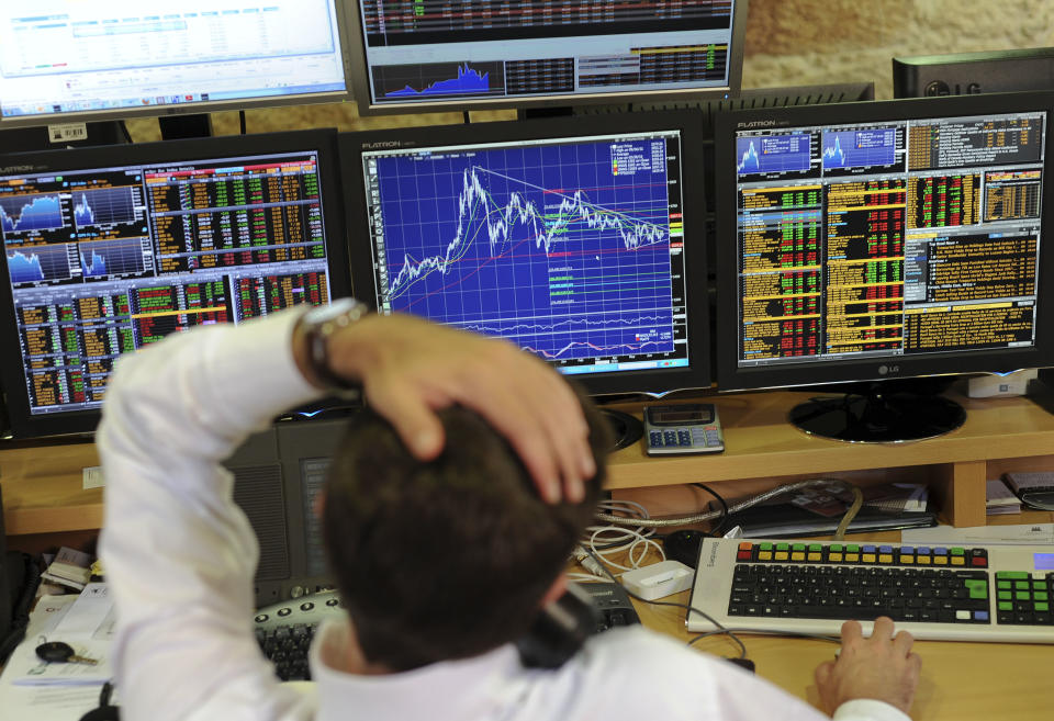 A broker speaks on the telephone while working in the trade room of a Portuguese bank Wednesday, July 18, 2012, in Porto, Portugal. Bailed-out Portugal has managed to sell euro 2 billion ($2.5 billion) in short-term bonds at a lower cost than Spain, suggesting the much larger country's troubles are not spilling over to its neighbor. Spain and Italy are struggling to borrow money at affordable rates, and Greece, Ireland and Portugal have needed bailout loans from the other countries. (AP/Paulo Duarte)