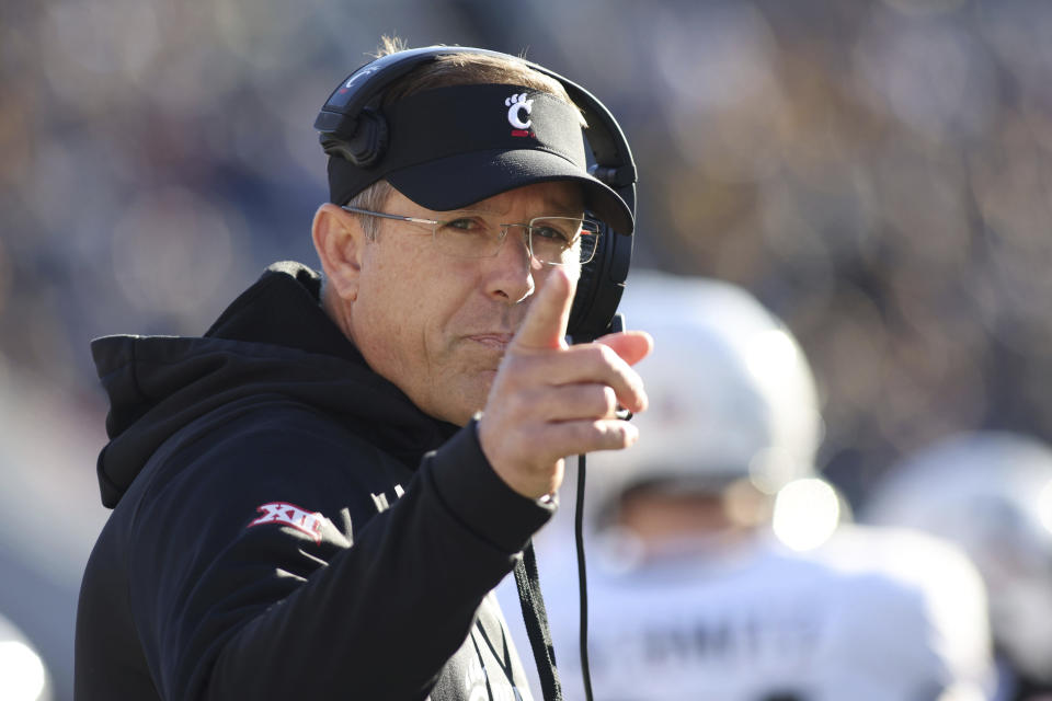 Cincinnati head coach Scott Satterfield points during the first half of an NCAA college football game against West Virginia, Saturday, Nov. 18, 2023, in Morgantown, W.Va. (AP Photo/Chris Jackson)