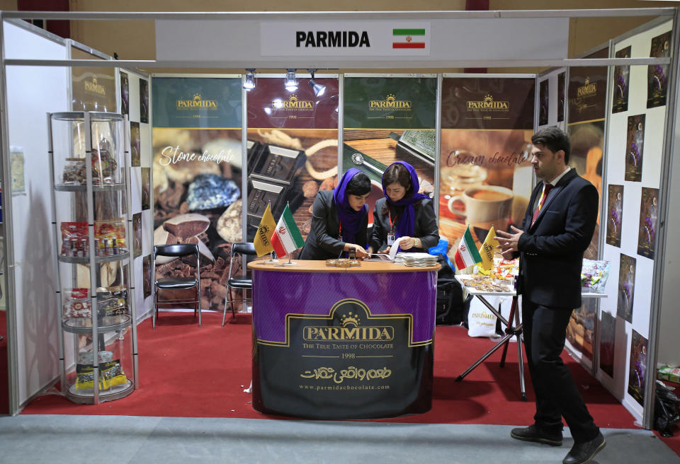 In this Saturday, Nov. 10, 2018 photo, visitors tour the Iranian wing of the Baghdad International Fair, in Baghdad, Iraq. Iran, already feeling the bite of U.S. sanctions, is turning to its neighbor Iraq to soak up some of its exports in agriculture, manufacturing and energy. At the Baghdad International Fair, Iran's ambassador says he wants to triple trade with Iraq. (AP Photo/Karim Kadim)