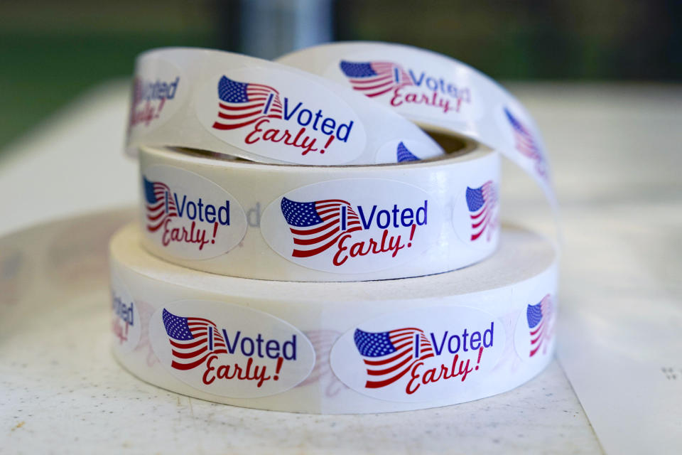 FILE - Rolls of "I Voted Early" stickers await voters in the final hours of early voting in the primary election in Noblesville, Ind., May 2, 2022. Election Day is still 12 days away. But in courtrooms across the country, efforts to sow doubt over the outcome have already begun. (AP Photo/Michael Conroy, File)