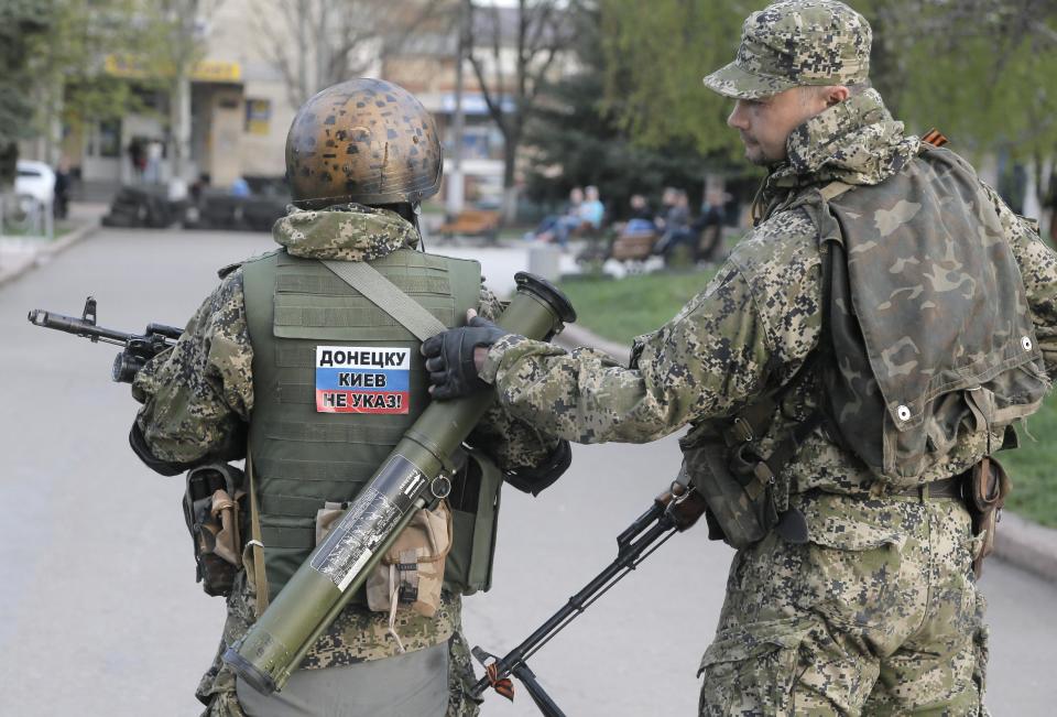 Pro-Russian gunman patrol a streets in downtown Slovyansk, Eastern Ukraine, Friday, April 18, 2014. Pro-Russian insurgents defiantly refused Friday to surrender their weapons or give up government buildings in eastern Ukraine, despite a diplomatic accord reached in Geneva and overtures from the government in Kiev. (AP Photo/Efrem Lukatsky)