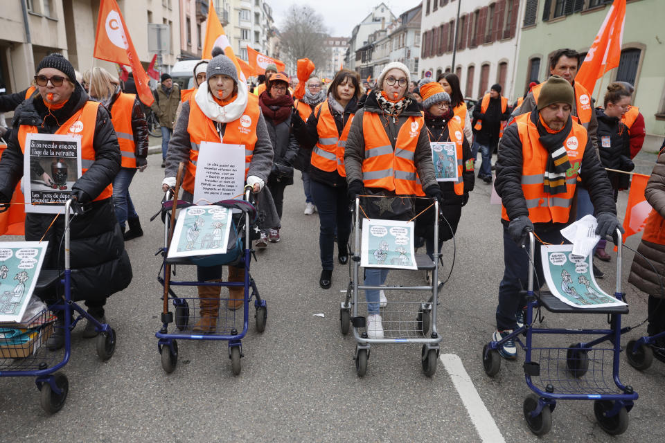 Protestors march with walkers as they demonstrate against proposed pension changes,Thursday, Jan. 19, 2023 in Strasbourg, eastern France. Workers in many French cities took to the streets to reject proposed pension changes that would push back the retirement age, amid a day of nationwide strikes and protests seen as a major test for Emmanuel Macron and his presidency. (AP Photo/Jean-Francois Badias)