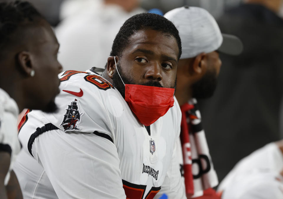 Aug 14, 2021; Tampa, Florida, USA; Tampa Bay Buccaneers offensive tackle Donovan Smith (76) wears a mask on the sidelines during the second quarter against the Cincinnati Bengals at Raymond James Stadium. Mandatory Credit: Kim Klement-USA TODAY Sports