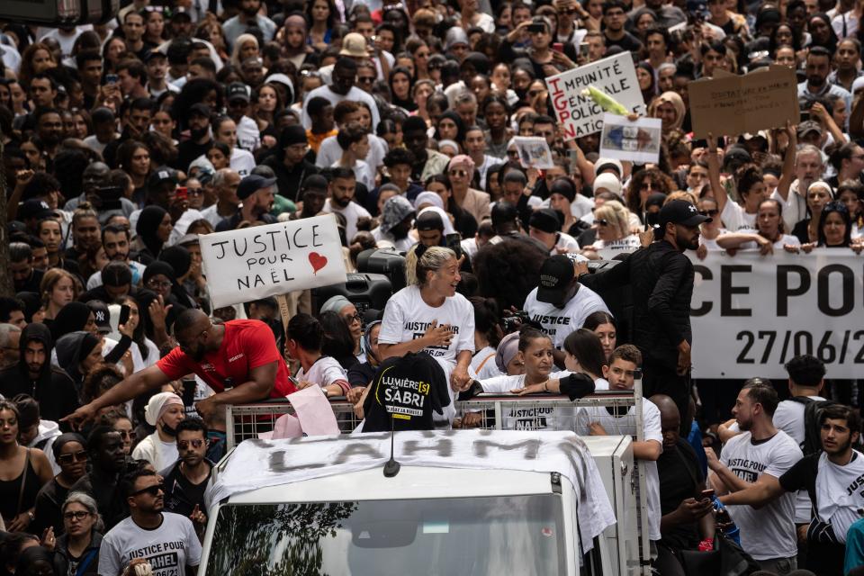 Mounia, mother of the French teenager killed by police, (C) reacts as she attends a memorial march for her son Nahel  on June 29, 2023 in Nanterre, France.