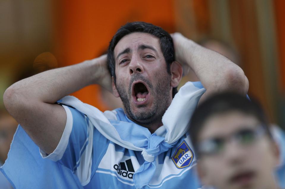 A fan of Argentina reacts while watching a broadcast of the 2014 World Cup final against Germany at the Argentine Embassy in Brasilia, July 13, 2014. REUTERS/Ueslei Marcelino (BRAZIL - Tags: SOCCER SPORT WORLD CUP)