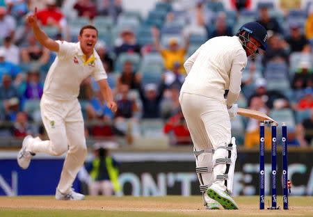 Cricket - Ashes test match - Australia v England - WACA Ground, Perth, Australia, December 18, 2017. Australia's Josh Hazlewood celebrates as he bowls England's Jonny Bairstow during the fifth day of the third Ashes cricket test match. REUTERS/David Gray