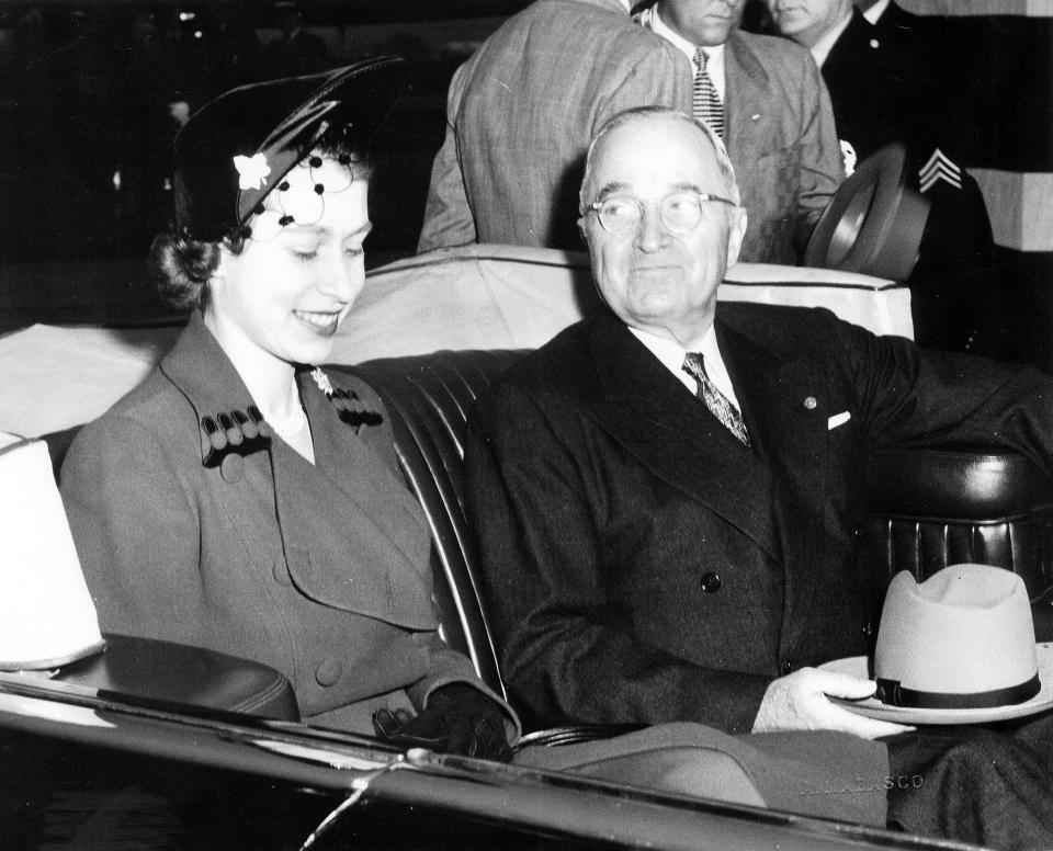 American President Harry Truman and Elizabeth II, sitting next to each other in the back of the Lincoln Cosmopolitan Presidential state car, with the convertible top open, Washington, DC, October 31, 1951. Image courtesy National Archives. / Credit: Smith Collection/Gado/Getty Images