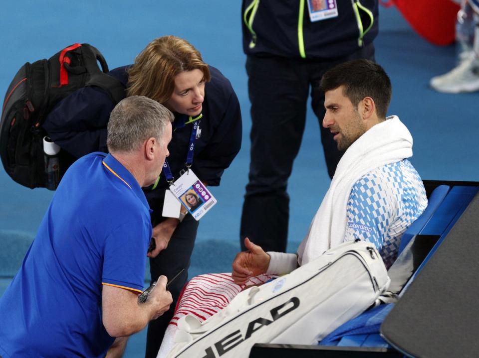 Novak Djokovic is given treatment for his hamstring injury (REUTERS)