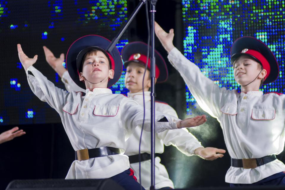 Young artists perform as people gather at the Christmas tree decorated for Christmas and the New Year festivities in Luhansk, the capital of Russian-controlled Luhansk region, eastern Ukraine, Friday, Dec. 23, 2022. (AP Photo)