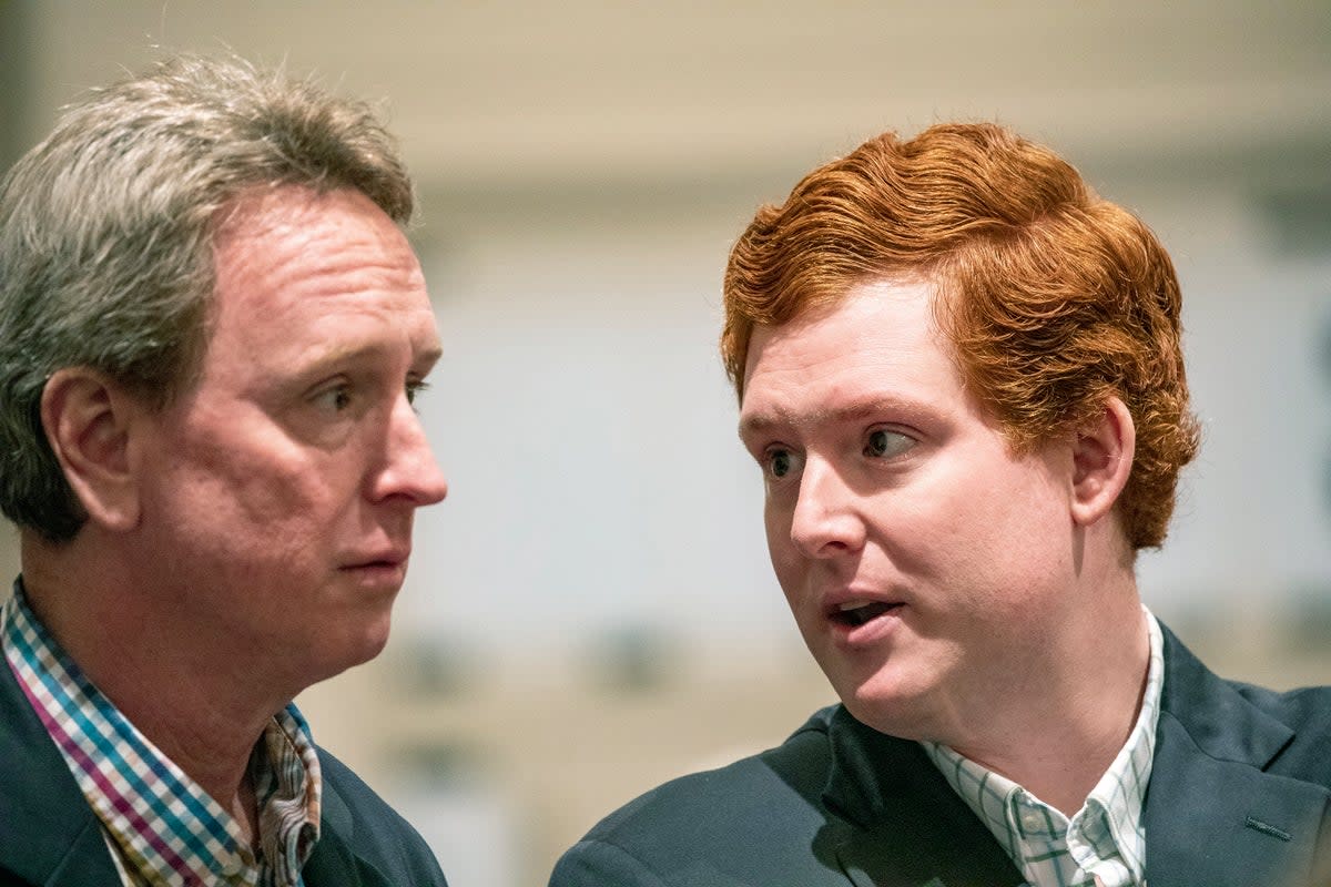 John Marvin Murdaugh and Buster Murdaugh talk in the double murder trial of Alex Murdaugh (AP)