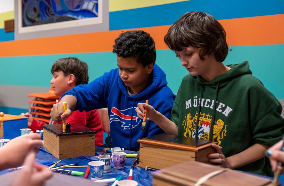 Young people work on a craft project on Monday, Dec. 12, 2022, at a meeting for Brooke’s Place, which helps grieving young people. 