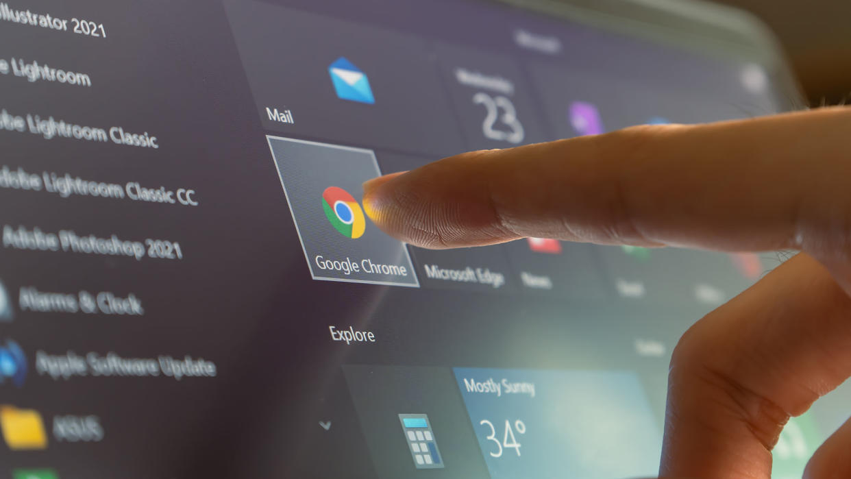  A finger touching the google chrome icon in the Windows 10 start menu. 