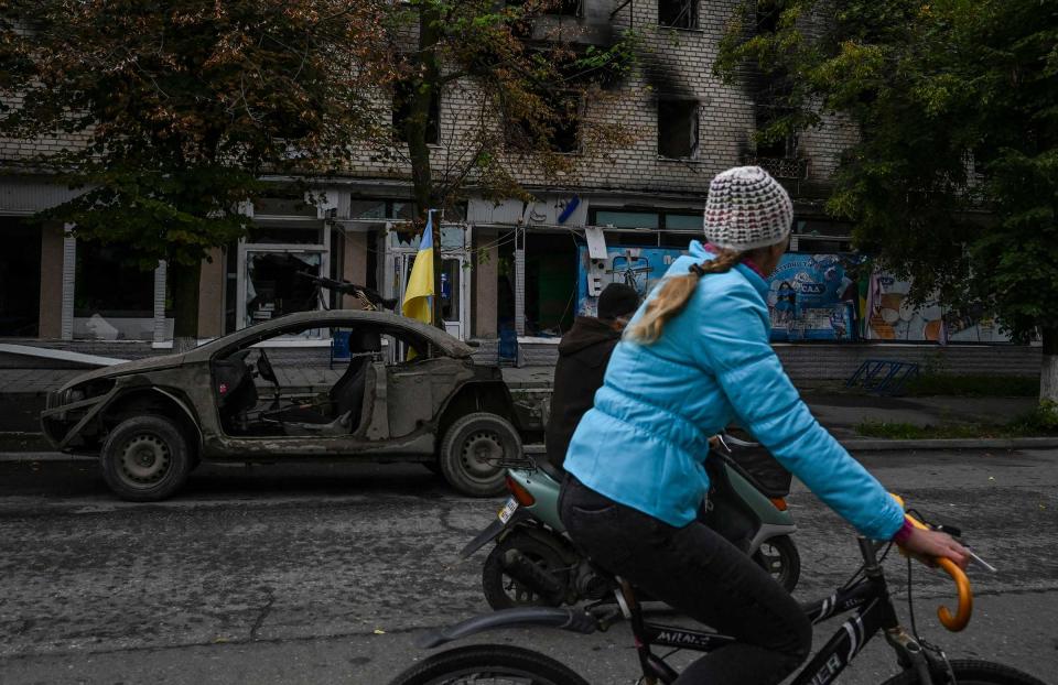 A woman rides a bicycle on a street in Izyum, Sept. 14.<span class="copyright">Juan Barreto—AFP/Getty Images</span>