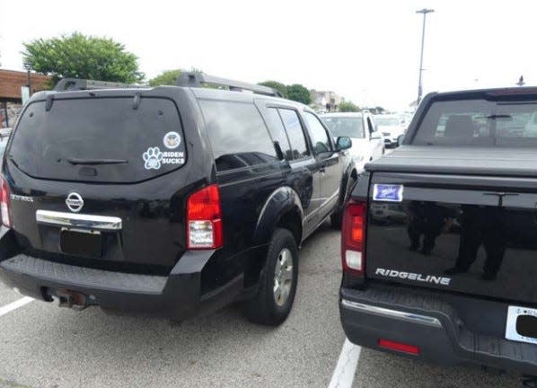 State Sen. Joshua Miller is accused of damaging the truck on the left, which displays an anti-Biden sticker.