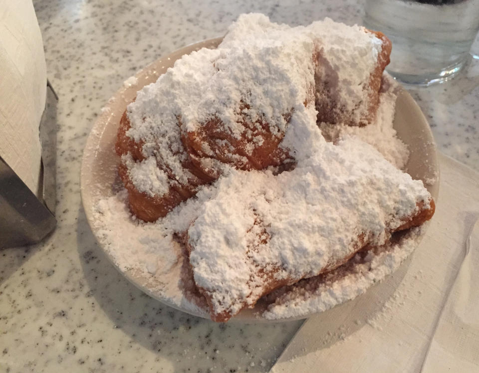 Beignets Garnished With Powdered Sugar On Plate